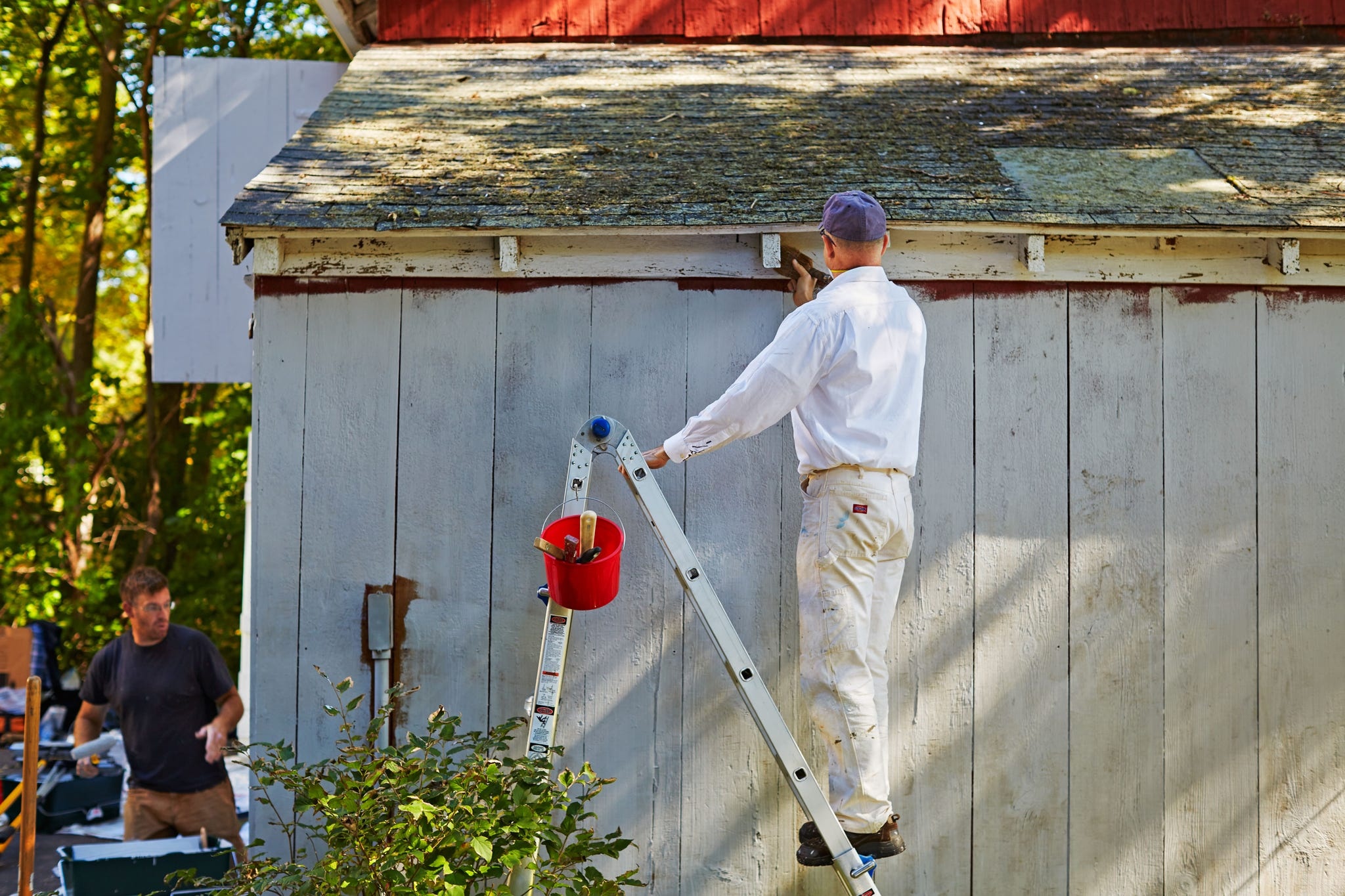 Professional airless spray painting equipment in action