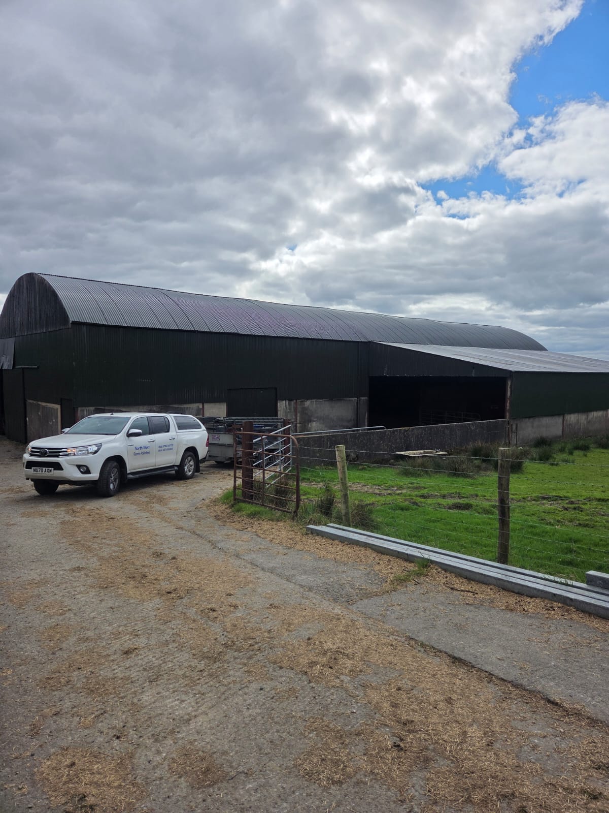 Large freshly painted barn with Northwest Farm Sprayers company van